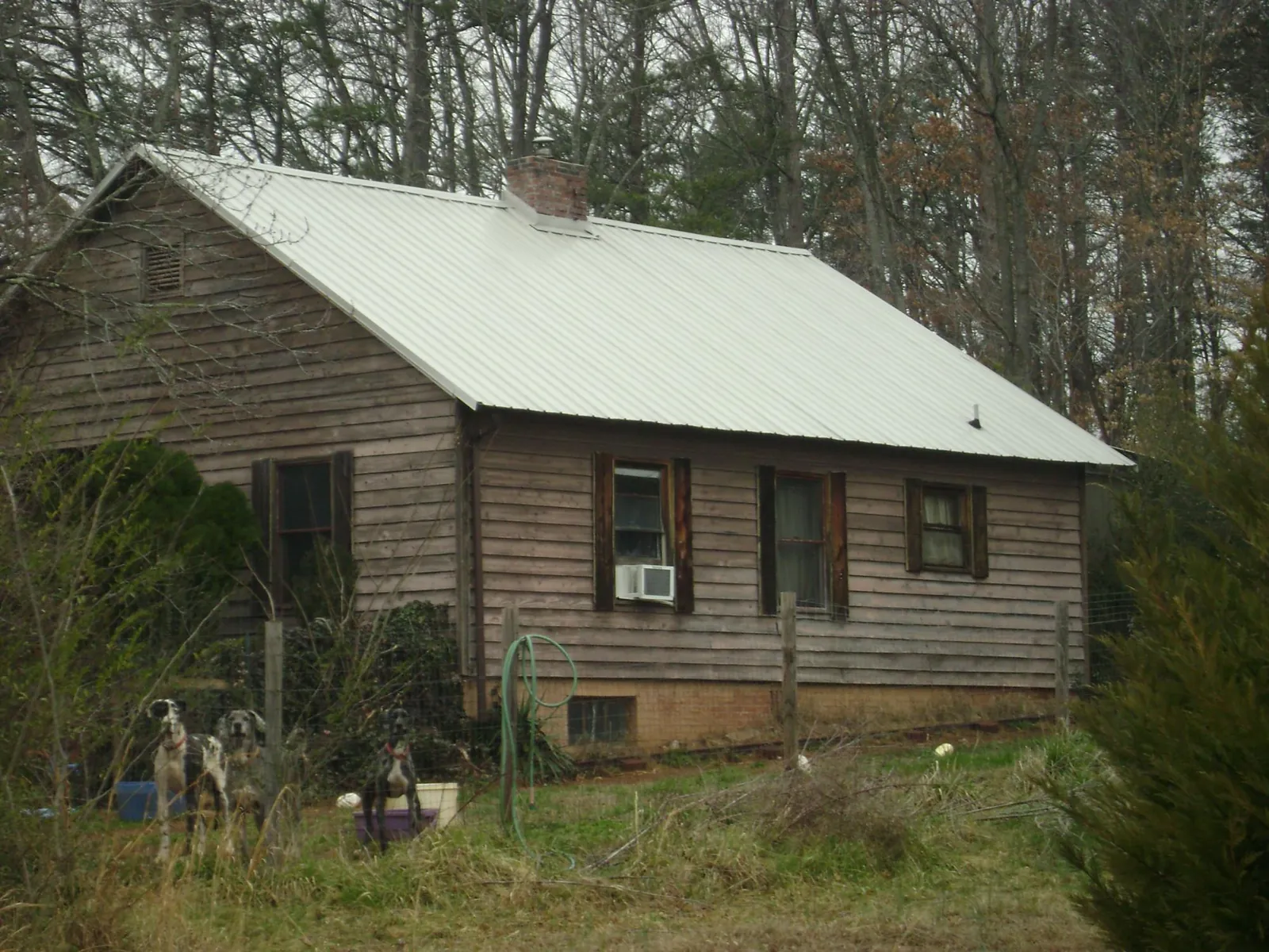 White metal roof on an old wood sided farmhouse, from a Metal Roof Installation job in Bowling Green